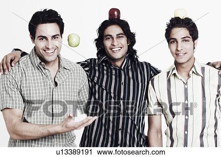 Stock Image - Portrait of three young men smiling. Fotosearch