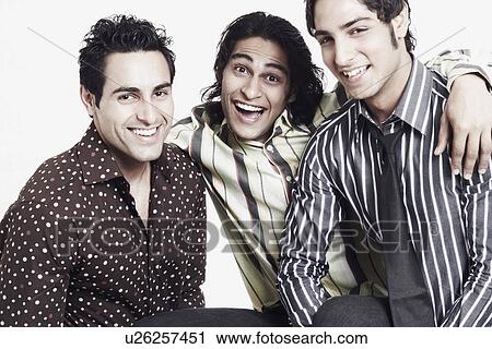 Stock Image - Portrait of three young men smiling. Fotosearch