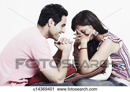 Side profile of a young couple smiling View Large Photo Image Stock Image - Side profile of a young couple smiling. Fotosearch