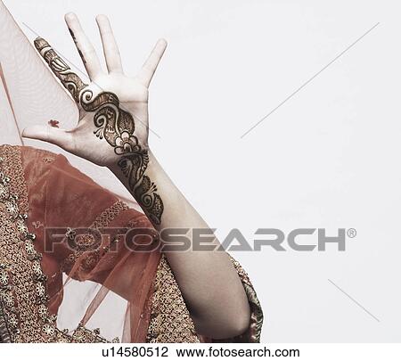 Stock Image - Close-up of a young woman with henna tattoo's on her hand. Fotosearch