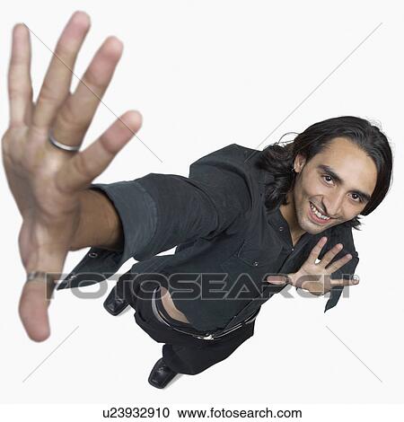 Stock Image - High angle view of a young man gesturing. Fotosearch