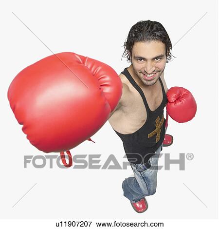 Stock Photo - High angle view of a young man wearing boxing gloves. Fotosearch