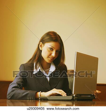 Portrait of a businesswoman using a laptop View Large Photo Image Stock Photography - Portrait of a businesswoman using a laptop. Fotosearch