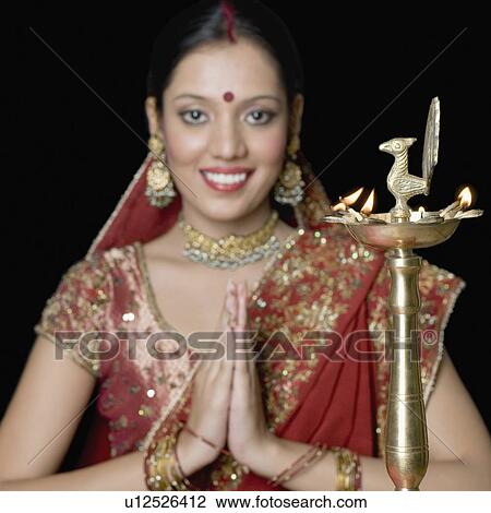 Portrait of a young woman in a prayer position View Large Photo Image Stock Image - Portrait of a young woman in a prayer position. Fotosearch