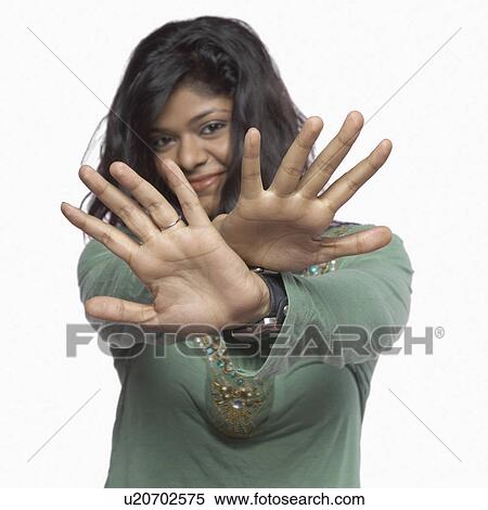 Stock Photography - Portrait of a young woman making a stop gesture. Fotosearch
