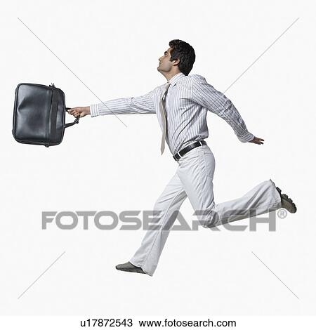 Side profile of a businessman carrying a hand bag and running View Large Photo Image Stock Image - Side profile of a businessman carrying a hand bag and running. Fotosearch