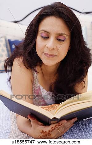 Close-up of a mid adult woman reading a book View Large Photo Image Stock Photo - Close-up of a mid adult woman reading a book. Fotosearch