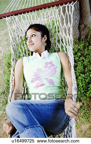 High angle view of a young woman lying in a hammock View Large Photo Image Stock Photography - High angle view of a young woman lying in a hammock. Fotosearch