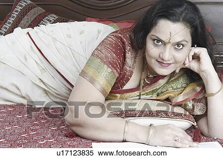 Portrait of a mature woman lying on the bed View Large Photo Image Stock Photography - Portrait of a mature woman lying on the bed. Fotosearch