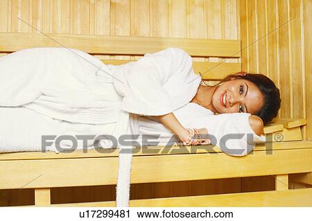 Portrait of a young woman lying in a sauna View Large Photo Image Stock Image - Portrait of a young woman lying in a sauna. Fotosearch
