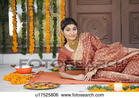 Stock Photograph - Portrait of a young woman lying on a mat. Fotosearch