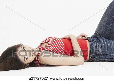 Portrait of a young woman lying on her back View Large Photo Image Stock Photo - Portrait of a young woman lying on her back. Fotosearch