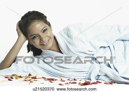 Portrait of a young woman sitting on a massage table View Large Photo Image Stock Image - Portrait of a young woman sitting on a massage table. Fotosearch