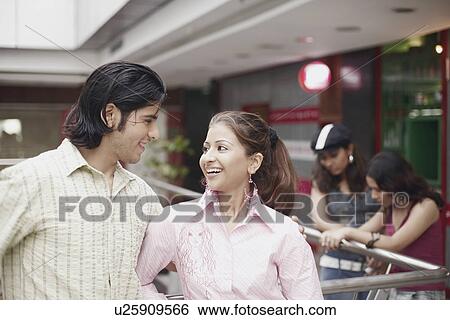 Close-up of a young couple looking at each other View Large Photo Image Stock Photograph - Close-up of a young couple looking at each other. Fotosearch