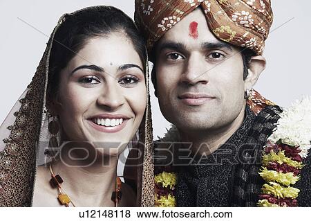 Stock Photo - Portrait of a newlywed couple smiling. Fotosearch