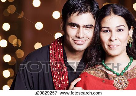 Portrait of a young couple smiling View Large Photo Image Stock Photo - Portrait of a young couple smiling. Fotosearch