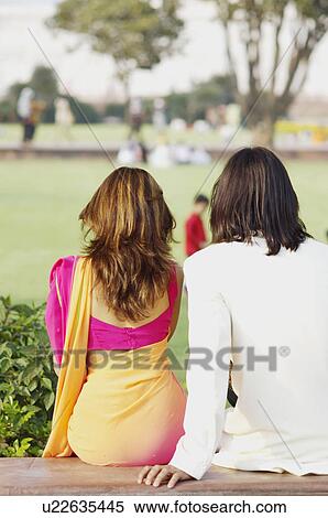 Rear view of a young couple sitting, Agra, Uttar Pradesh, India View Large Photo Image Stock Photography - Rear view of a young couple sitting, Agra, Uttar Pradesh, India. Fotosearch