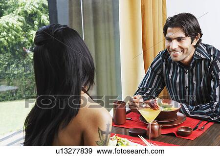Stock Photo - Young couple dining in a restaurant. Fotosearch