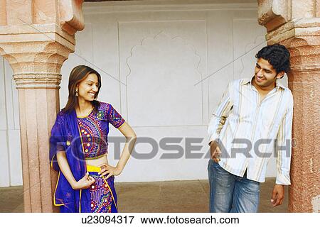 Young couple leaning against two columns and looking at each other View Large Photo Image Stock Photo - Young couple leaning against two columns and looking at each other. Fotosearch