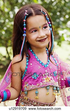 Close-up of a girl grinning View Large Photo Image Stock Photo - Close-up of a girl grinning. Fotosearch