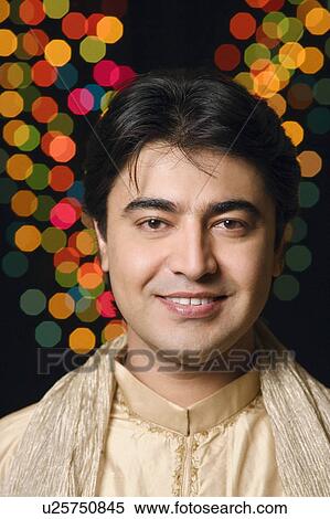 Portrait of a young man wearing traditional Indian clothing and smiling View Large Photo Image Stock Photography - Portrait of a young man wearing traditional Indian clothing and smiling. Fotosearch