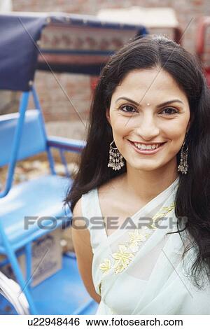 Portrait of a young woman smiling View Large Photo Image Stock Photograph - Portrait of a young woman smiling. Fotosearch
