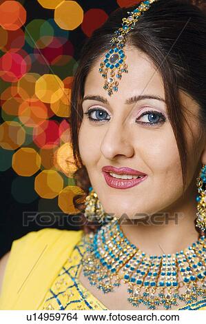 Portrait of a young woman wearing traditional Indian clothing View Large Photo Image Picture - Portrait of a young woman wearing traditional Indian clothing. Fotosearch