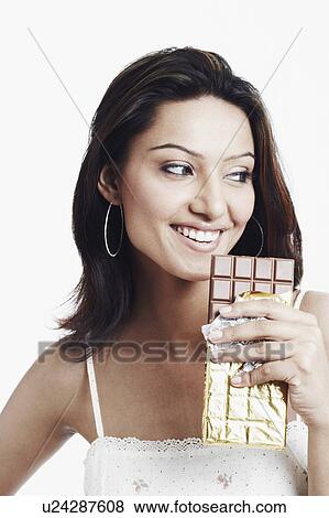 Close-up of a young woman holding a slab of chocolate View Large Photo Image Stock Photo - Close-up of a young woman holding a slab of chocolate. Fotosearch