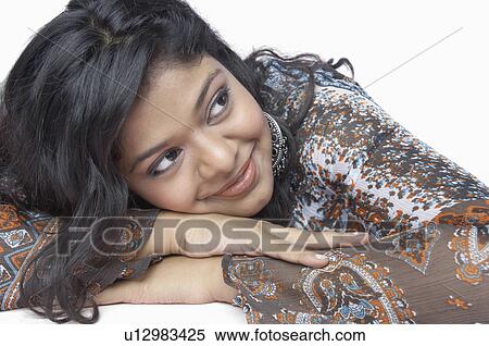Close-up of a young woman resting her head on her hands View Large Photo Image Stock Photography - Close-up of a young woman resting her head on her hands. Fotosearch