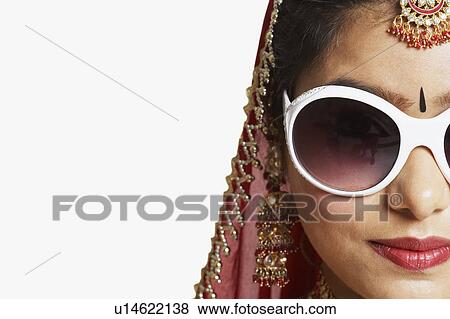 Stock Photo - Close-up of a young woman wearing sunglasses. Fotosearch