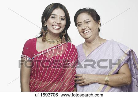 Stock Photograph - Portrait of a mature woman and a mid adult woman standing together. Fotosearch