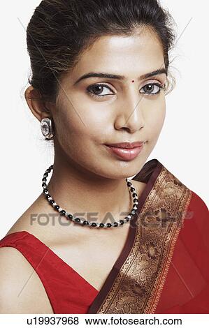 Stock Photo - Portrait of a young woman wearing a sari. Fotosearch