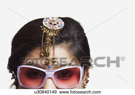 Stock Photo - Portrait of a young woman wearing a pair of sunglasses. Fotosearch