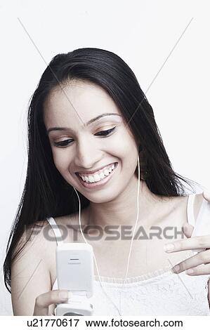 Close-up of a teenage girl holding a mobile phone View Large Photo Image Stock Photo - Close-up of a teenage girl holding a mobile phone. Fotosearch