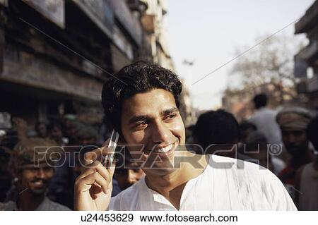 Stock Photo - Close-up of a young man talking on a mobile phone. Fotosearch