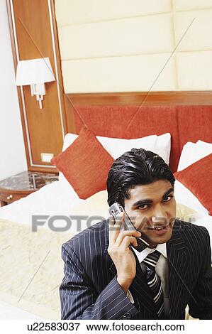 Stock Photo - Portrait of a businessman talking on a mobile phone. Fotosearch