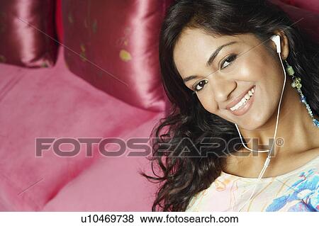 Stock Photo - Portrait of a young woman wearing headphones. Fotosearch