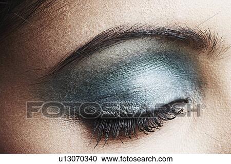 Close-up of a young woman with her eye closed View Large Photo Image Stock Image - Close-up of a young woman with her eye closed. Fotosearch