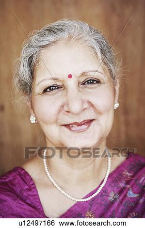 Stock Photograph - Portrait of a mature woman smiling. Fotosearch