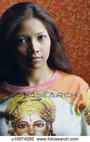Stock Image - Portrait of a young woman looking serious. Fotosearch