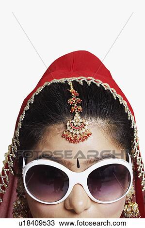 Stock Image - Close-up of a young woman wearing sunglasses. Fotosearch