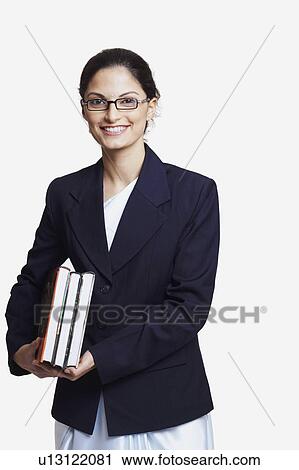 Portrait of a businesswoman holding books and smiling View Large Photo Image Stock Image - Portrait of a businesswoman holding books and smiling. Fotosearch
