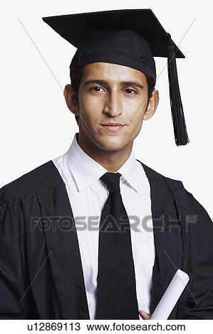 Portrait of a male graduate holding a diploma View Large Photo Image Stock Image - Portrait of a male graduate holding a diploma. Fotosearch
