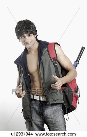 Portrait of a young man carrying a backpack View Large Photo Image Picture - Portrait of a young man carrying a backpack. Fotosearch
