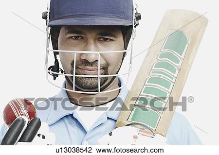 Portrait of a young man holding a cricket bat and a cricket ball View Large Photo Image Stock Image - Portrait of a young man holding a cricket bat and a cricket ball. Fotosearch