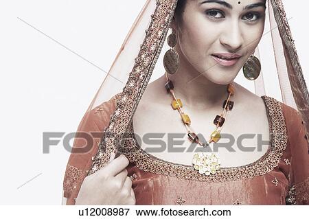 Stock Photo - Portrait of a young woman in traditional clothing. Fotosearch