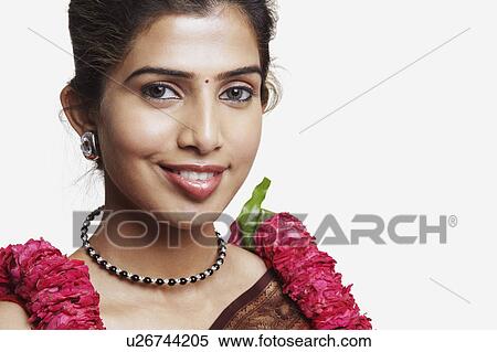 Stock Photography - Portrait of a young woman wearing a sari and a garland. Fotosearch