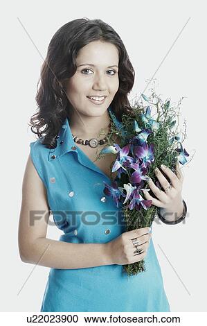 Portrait of a young woman with a bouquet of flowers smiling View Large Photo Image Stock Image - Portrait of a young woman with a bouquet of flowers smiling. Fotosearch