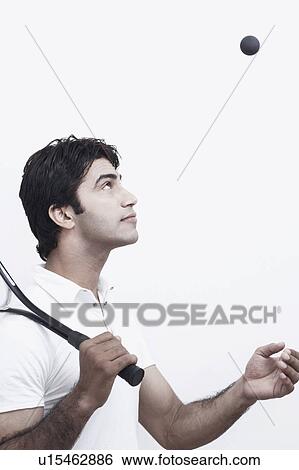 Side profile of a young man tossing a ball View Large Photo Image Stock Photograph - Side profile of a young man tossing a ball. Fotosearch