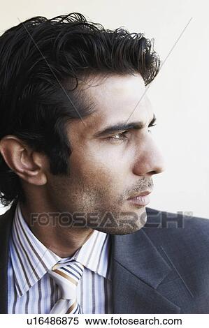 Stock Photography - Close-up of a young man looking away. Fotosearch